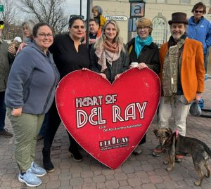 Friends of Duncan Library members stand around large Heart of Del Ray heart